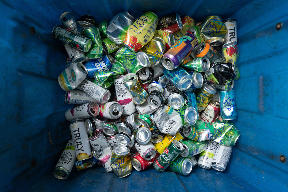 image of aluminum cans filling a recycling bin