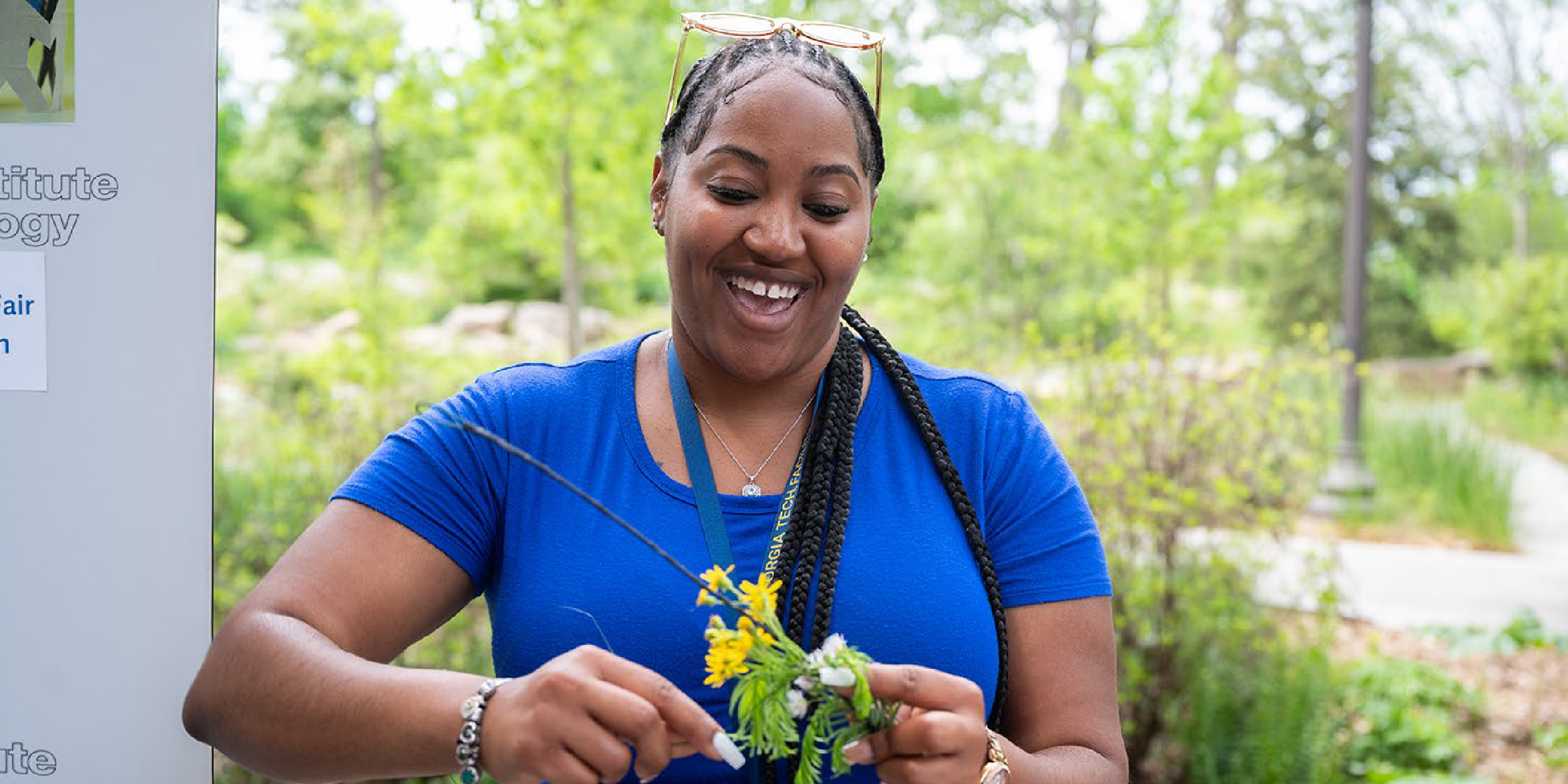 Women caring for a plant at earth day event