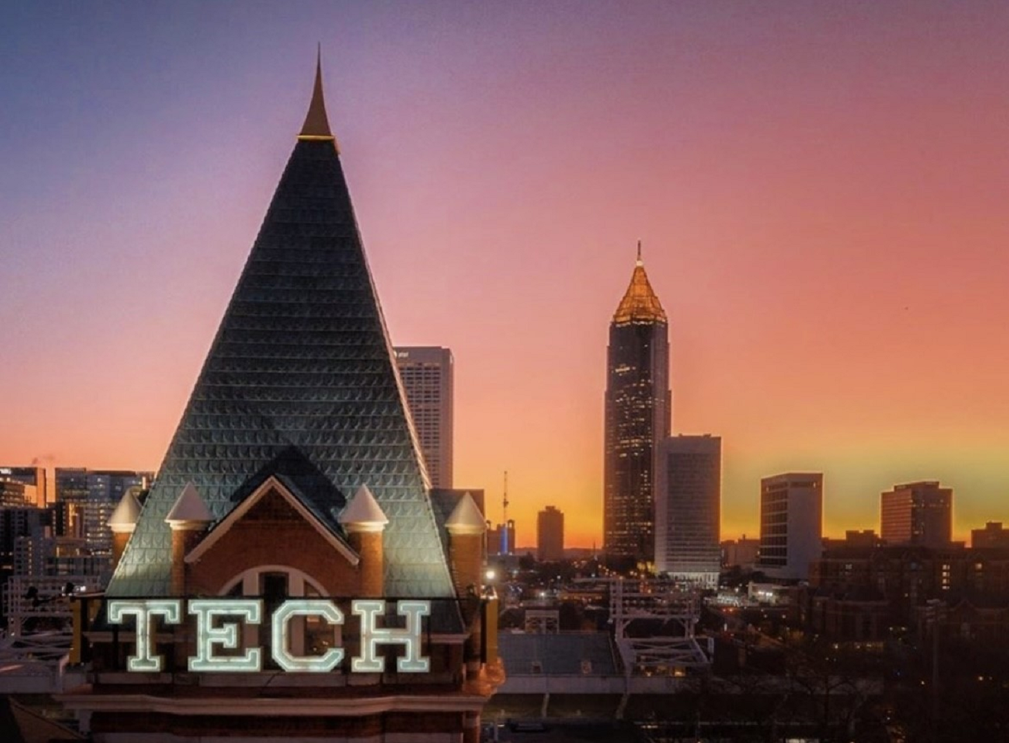 Tech Tower with Atlanta skyline at sunset