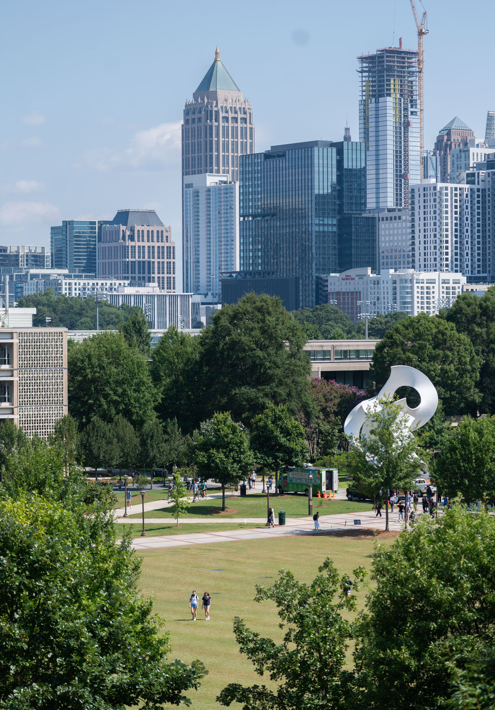 Tech campus with trees and the Atlanta skyline in the background