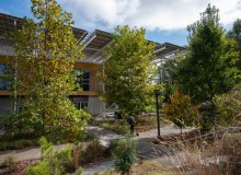 Image of micromobility user in the EcoCommons performance landscape adjacent to The Kendeda Building for Innovative Sustainable Design